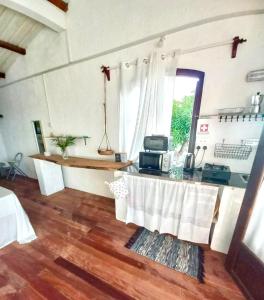 a room with a table with a microwave on it at Residence Ma Vie Là Ltee in Le Morne