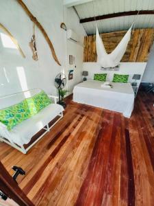 a bedroom with two beds and a wooden floor at Residence Ma Vie Là Ltee in Le Morne