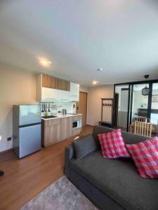 a living room with a couch and a kitchen at Title V in Rawai Beach +39 photos