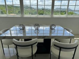 comedor con mesa y sillas en NEW Luxury VILLA CapEstate Saint Lucia Ocean View en Cap Estate