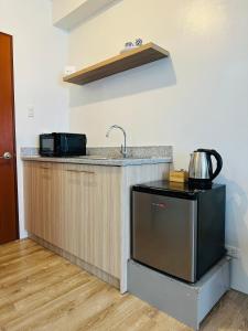 a kitchen with a sink and a counter at Cozy Condo bedroom in Bacolod City in Bacolod