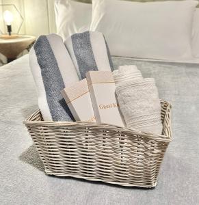 a basket of towels and towels on a bed at Cozy Condo bedroom in Bacolod City in Bacolod