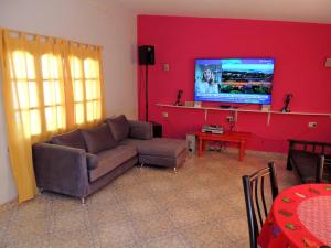 a living room with a couch and a flat screen tv at Alquiler de casa El Oeste in Villa Unión
