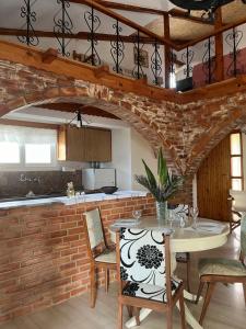 a kitchen with a brick wall and a table and chairs at Kamera House in Khordhákion