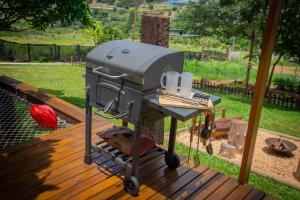 a grill sitting on a table on a deck at T24 Tinyhouse Container in Ibiúna