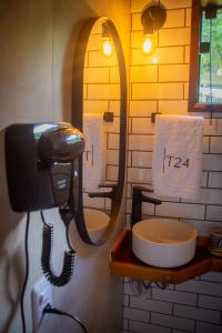 a bathroom with a blow dryer and a sink at T24 Tinyhouse Container in Ibiúna