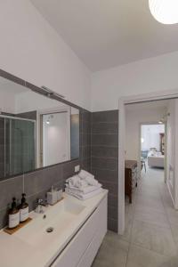 a bathroom with a sink and a mirror at Alba House Malpensa Airport in Gallarate +36 photos
