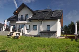 a house with a lot of solar panels on it at Apartamenty ,,Górska Strefa'' Czorsztyn in Czorsztyn