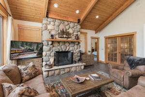 a living room with a large stone fireplace at 4920 County Rd 203 in Hermosa