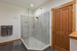 a bathroom with a shower with a glass door at 4920 County Rd 203 in Hermosa +39 photos