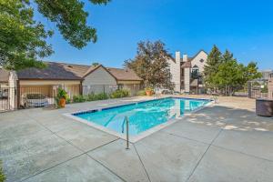 a swimming pool in front of a house at Boston Commons - 1143 in Greenwood Village