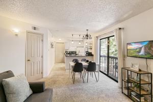 a living room and kitchen with a table and chairs at Boston Commons - 1263 in Greenwood Village