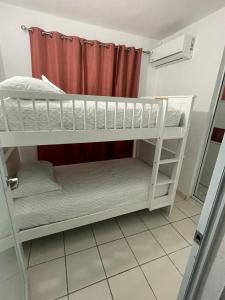 サンファンにあるMindanao # 842の赤いカーテン付きの客室で、二段ベッド2台が備わります。