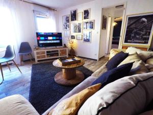 a living room with a couch and a table at Le Cocoon - SIPCO Immobilier - Netflix in Saint Lo