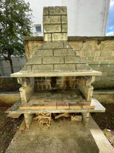 una panca di pietra seduta accanto a un muro di mattoni di Apartman Noel Knin a Knin (Tenin)