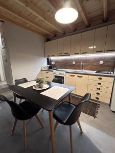 a kitchen with a table and chairs and a sink at Celeste Loft in Tríkala