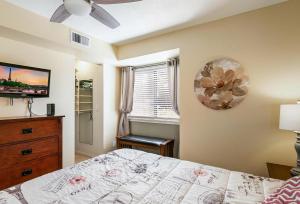a bedroom with a bed and a dresser and a window at Boston Commons - 1167 in Greenwood Village