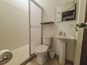een badkamer met een toilet, een wastafel en een douche bij Hacienda Nápoles y Santorini Agradable y Fresco Apto in Doradal