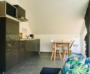 a small kitchen and a table in a room at Greenhouse in Sart-lez-Spa