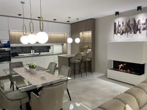 a kitchen and dining room with a table and a fireplace at Luxury Home with Jakuzzi near Neusiedler See in Fertőszentmiklós