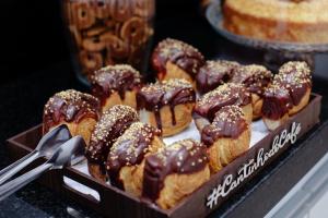 a box of chocolate covered donuts on a table at Hotel Madrugada in São Paulo