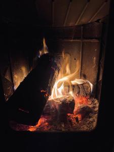 a fire in a brick oven with flames in it at Guest House Mare in Bar