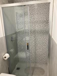 a shower with a glass door in a bathroom at Appartamento Casa Roby in Montecatini Terme
