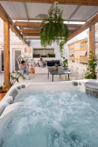 a hot tub in the middle of a living room at Naim Playa in Cala del Moral