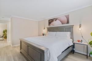 a bedroom with a large bed with white sheets at G - Atlanta Luxury 1bdr 1bath ensuite shared Condo in prime location in Atlanta