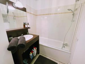a bathroom with a sink and a shower and a tub at Studio Disneyland Paris in Montévrain +22 photos