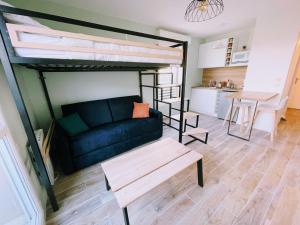 a living room with a couch and a loft bed at Studio Disneyland Paris in Montévrain