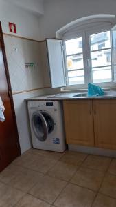 a washing machine in a kitchen next to a window at Paradise in Cabanas de Tavira in Cabanas de Tavira