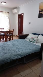 a bedroom with a bed and a dining room at Paradise in Cabanas de Tavira in Cabanas de Tavira
