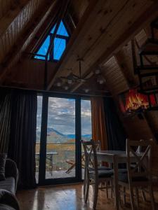 a dining room with a table and a large window at HillSide Cottage in Keda