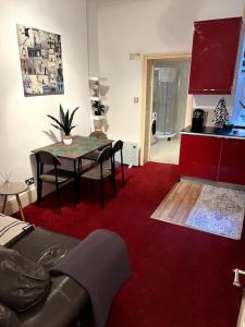 a living room with a table and a red carpet at Flat in Central London in London