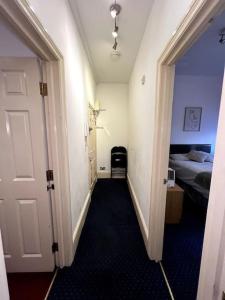 a hallway of a room with a bed and a door at Flat in Central London in London