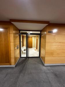 an empty hallway in a building with glass doors at EL PASEO DEL DUERO in Zamora