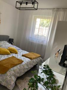 a bedroom with a bed and a window at LOFT-LUX Apartment in Jelenia Góra