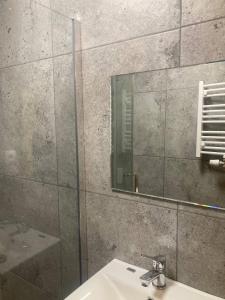 a bathroom with a sink and a mirror at LOFT-LUX Apartment in Jelenia Góra +15 photos