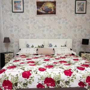 a bedroom with a bed with red flowers on it at Posada Serena in Bologna