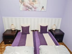 a bedroom with two beds and two night stands at Legata in Ostróda