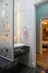 a bathroom with a sink and a mirror at The place4 Downtown Nest apartment in Cairo