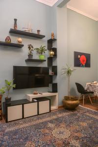 a living room with a flat screen tv on a wall at The place4 Downtown Nest apartment in Cairo