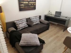 a living room with a couch and a piano at Central suite on Clock Square D1 in Veria