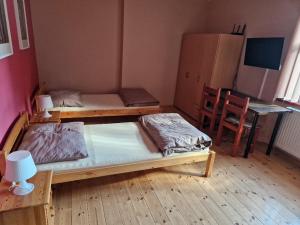 a room with two bunk beds and a desk at Penzion Kornout in Bílina