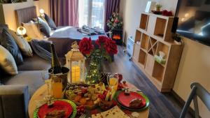 a table with food on it in a living room at Nature View Designer Studio in Tsaghkadzor