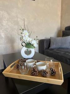 a coffee table with a vase and christmas decorations on it at Le Panoramique Gex in Gex
