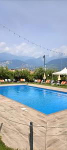a large blue swimming pool in a resort at Hotel Everest Arco in Arco