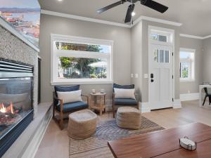 a living room with a fireplace and a table and chairs at Kennebeck Oasis - Private Patio, Steps 2 Sand & AC in San Diego