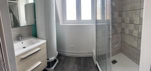 a bathroom with a glass shower and a sink at Pause En Seine- Appartement en duplex in Caudebec-en-Caux +18 photos